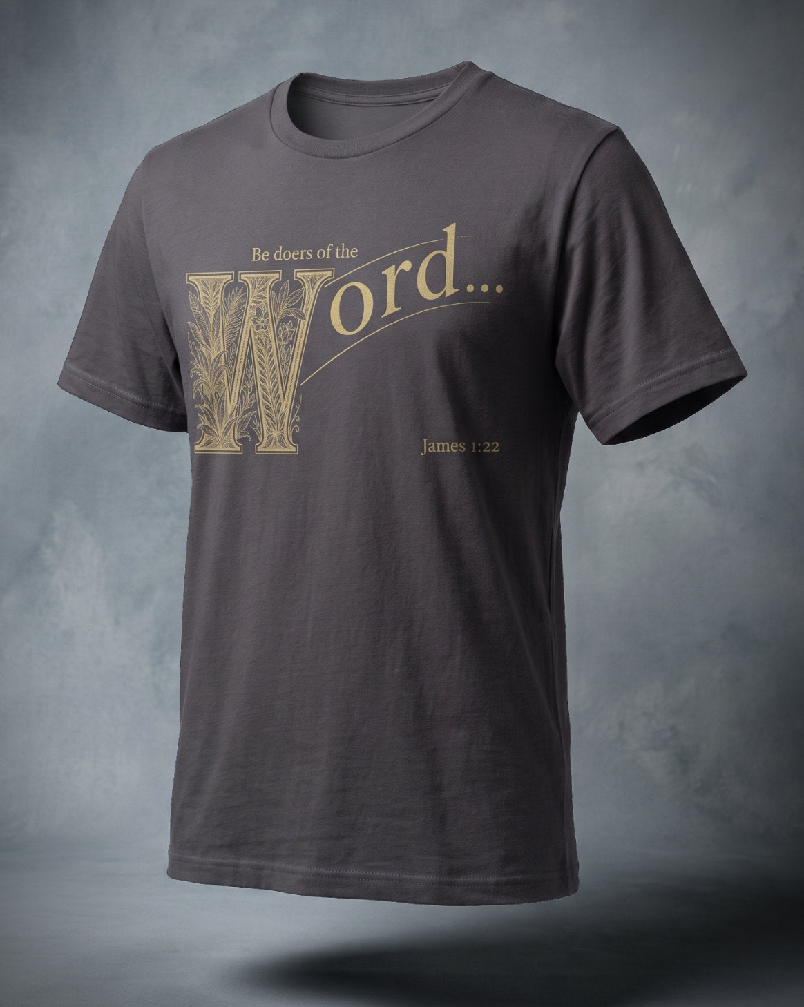 Be Doers of the Word t-shirt in charcoal with gold ornamental lettering and James 1:22, three-quarter studio view