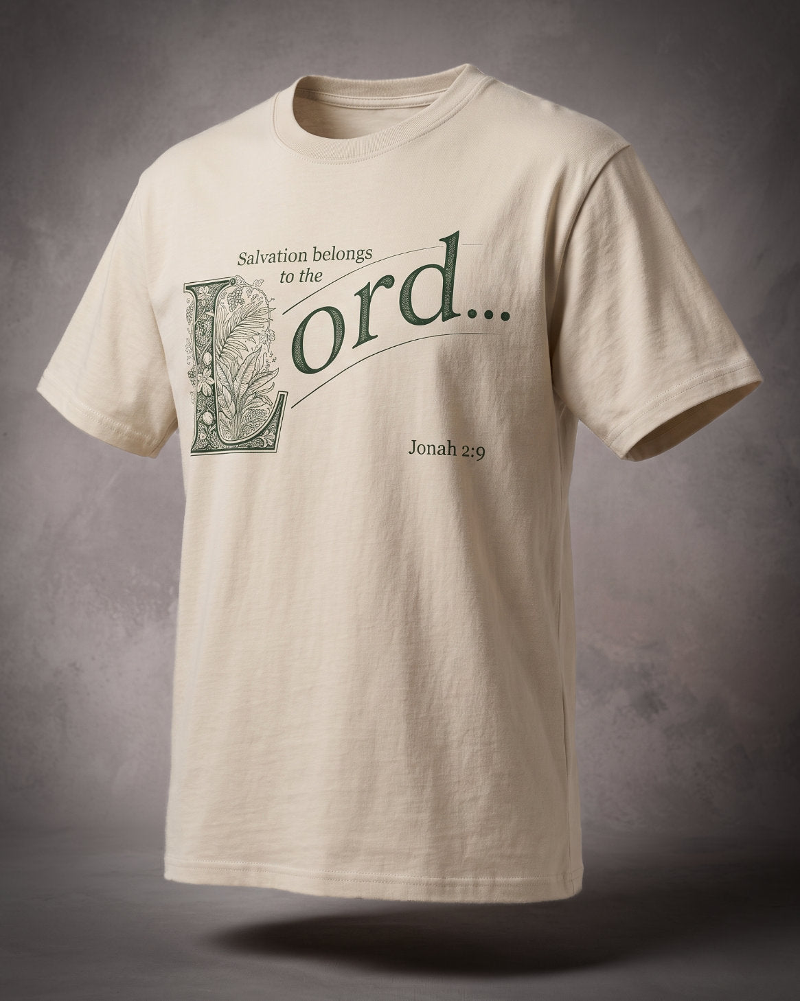 Salvation Belongs to the Lord t-shirt in sand with green ornamental lettering and Jonah 2:9, three-quarter studio view