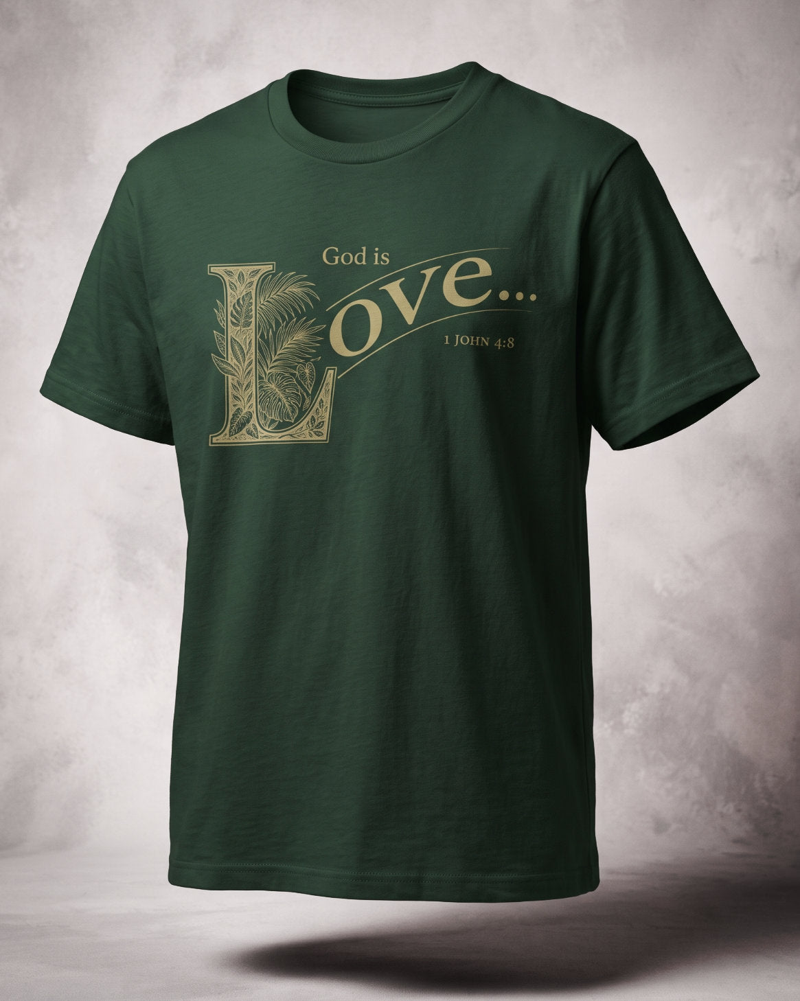 God Is Love t-shirt in forest green with gold ornamental lettering and 1 John 4:8, three-quarter studio view